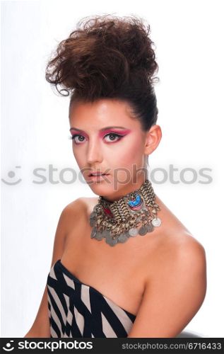 Beautiful young brunette wearing a necklace of coins