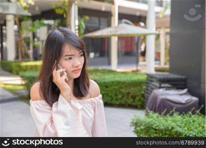 Beautiful young brunette woman calling by phone in the shop