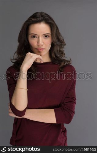 beautiful young brunette woman in a red blouse posing and expresses different emotions. close-up portret