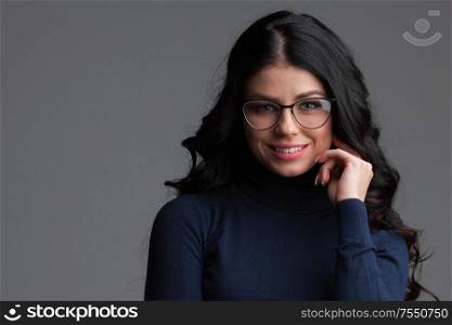 Beautiful young brunette woman in glasses , gray background, copy space for text. Beautiful woman in glasses