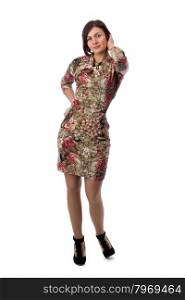 Beautiful young brunette woman with short hair in a dress with a floral pattern. Studio, isolate on white background.