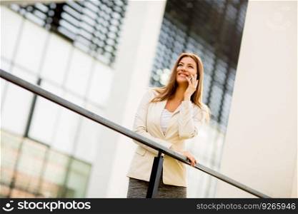 Beautiful young business woman calling by phone and smiling