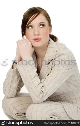Beautiful young business woman in beige suit. Shot in studio over white.