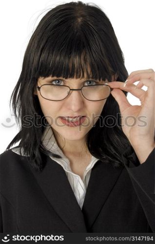 Beautiful young business woman looking over glasses. Black hair, blue eyes.