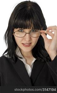 Beautiful young business woman looking over glasses. Black hair, blue eyes.