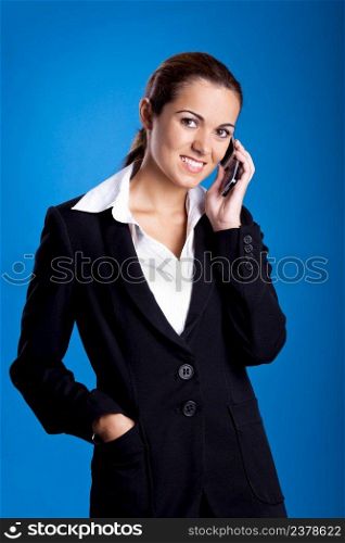 Beautiful young businesswoman calling by cellular phone.