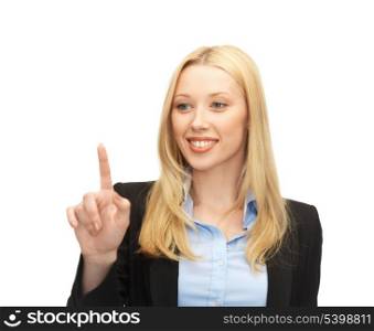 beautiful young businesswoman working with something imaginary