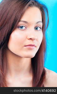 beautiful young caucasian woman on blue background