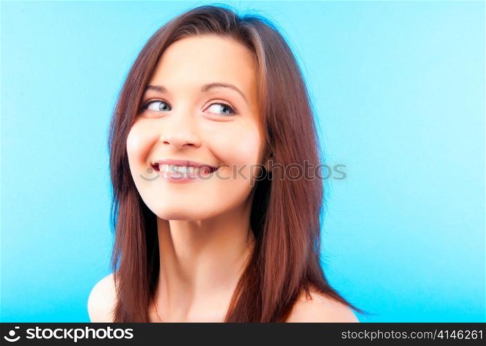 beautiful young caucasian woman on blue background