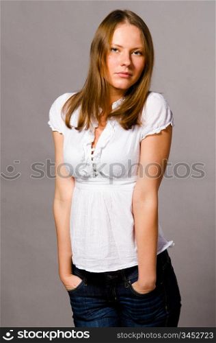 beautiful young caucasian woman on gray background