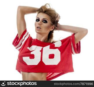 Beautiful young cheerleader in a red uniform with long hair. Isolated on a white background