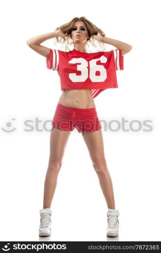 Beautiful young cheerleader in a red uniform with long hair. Isolated on a white background