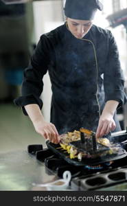 beautiful young chef woman prepare and decorating tasty food in kitchen