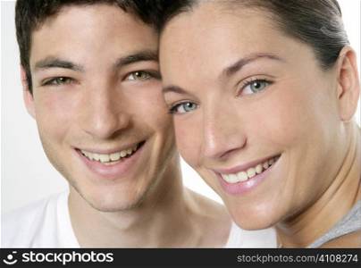 Beautiful young couple closeup portrait, two faces over white