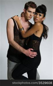 Beautiful young couple dressed in black mesh
