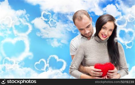 Beautiful young couple embracing and looking at camera. Standing at romantic background, designed in valentine style and ready to use