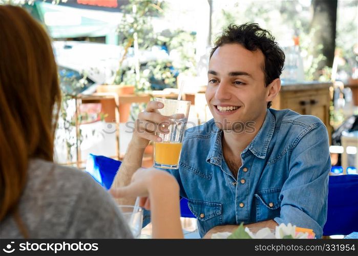 Beautiful young couple having breakfast at coffee shop.
