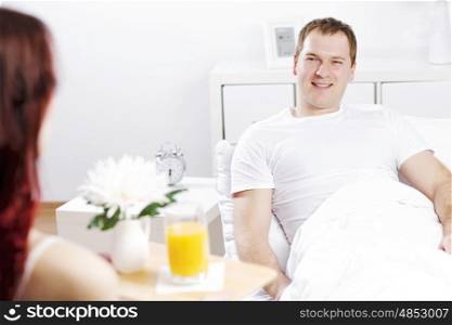 Beautiful young couple having breakfast in bed. Good morning darling