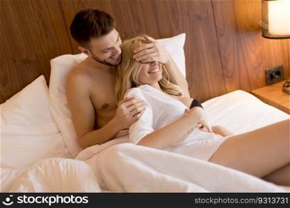 Beautiful young couple hugging while sleeping together in bed at home