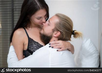 Beautiful young couple in love, man and woman in bed.