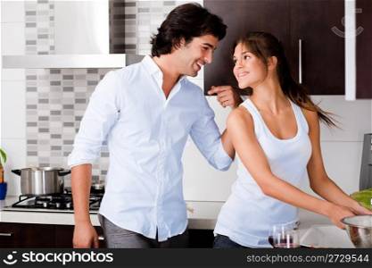 Beautiful young couple in the kitchen
