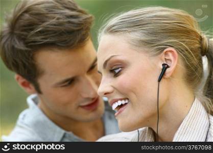 beautiful young couple listening to MP3 player