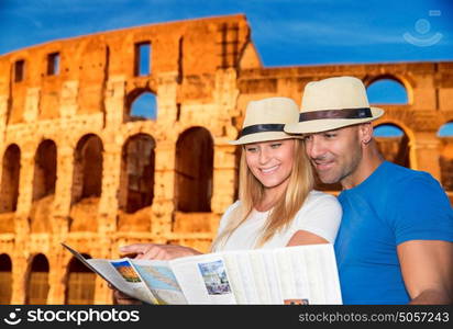 Beautiful young couple standing near Coliseum and looking in the map, searching right direction to next sightseeing, active summer vacation in Rome, Italy, Europe