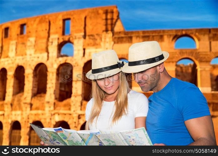 Beautiful young couple standing near Coliseum and looking in the map, searching right direction to next sightseeing, active summer vacation in Rome, Italy, Europe