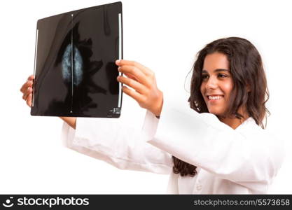Beautiful young doctor looking at a X-Ray, isolated over white
