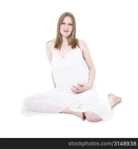 Beautiful young expecting mother in white over white high key portrait.