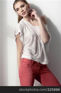 Beautiful young fashion girl model posing on white background