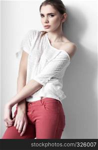 Beautiful young fashion girl model posing on white background