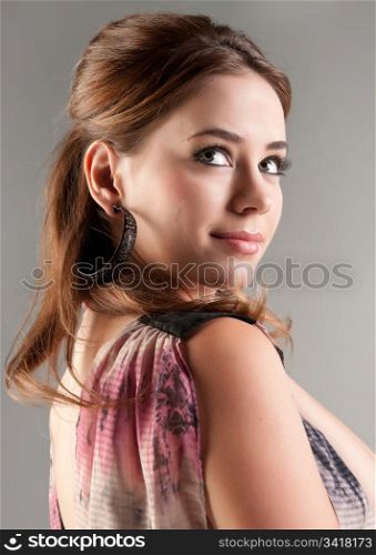 beautiful young fashion model woman on grey background