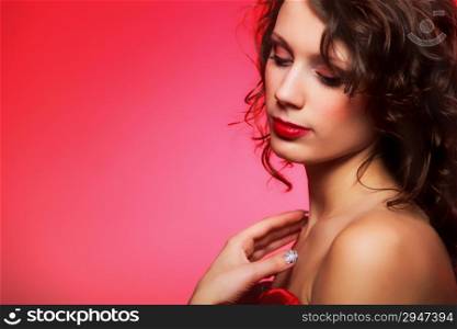 Beautiful young fashion woman with makeup on red background
