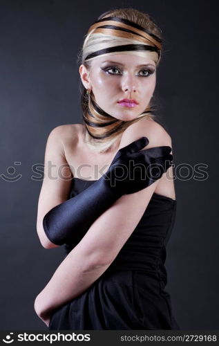 Beautiful young Female modell wearing black hand glove in her right hand