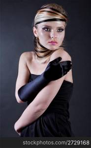 Beautiful young Female modell wearing black hand glove in her right hand