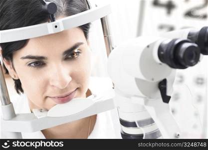 Beautiful young female patient is having a medical attendance at the optometrist.