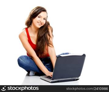 Beautiful young female student with a laptop, isolated on white