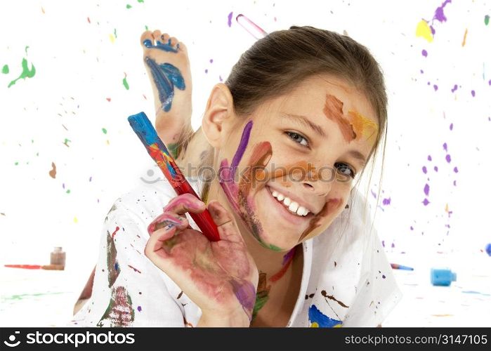 Beautiful young girl covered in paint.