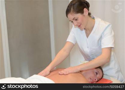 beautiful young girl having massage in spa salon