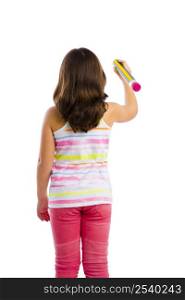 Beautiful young girl holding a big pencil and writing something on a glass wall