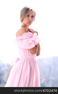 Beautiful young girl in pink dress
