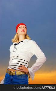 Beautiful young girl in red bandana over sunset sky