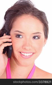 Beautiful young girl laying on a pillow chatting on a cell phone