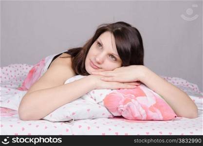 Beautiful young girl lying in the bed