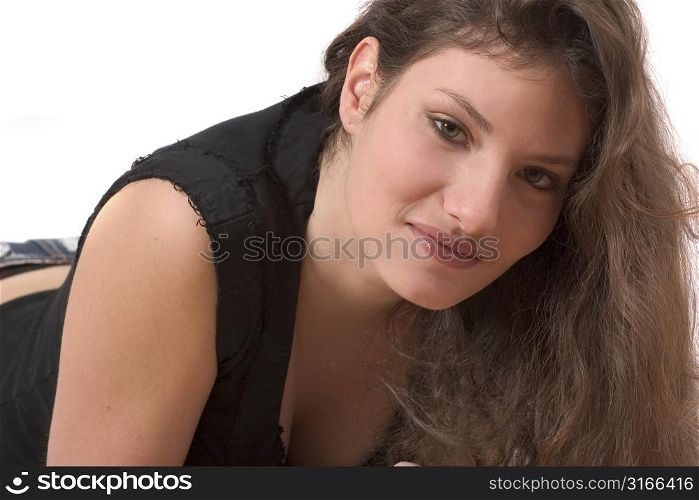 Beautiful young girl lying on white background