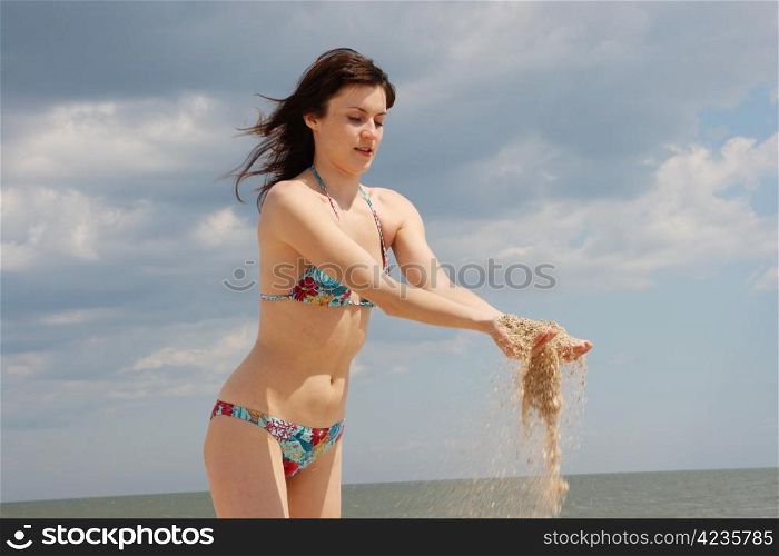 Beautiful young girl on a background a sea