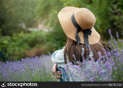Beautiful young girl on lavender field. Sunset. Attractive young fema≤outdoors.