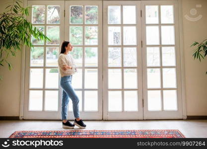 Beautiful young girl on the terrace looks in a large window in a cozy boutique hotel. Beautiful girl on the terrace looks in a large window in a cozy boutique hotel
