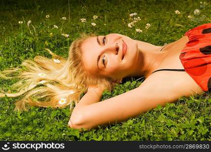 Beautiful young girl relaxing on a meadow